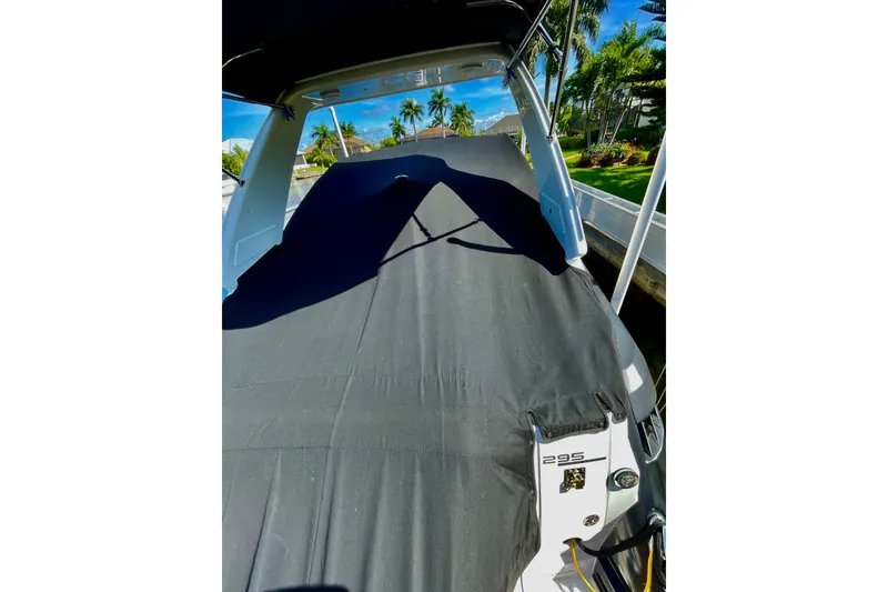 Slide: The Image of 2017 Monterey 295 Sport Yacht covered, docked near palm trees. - 28