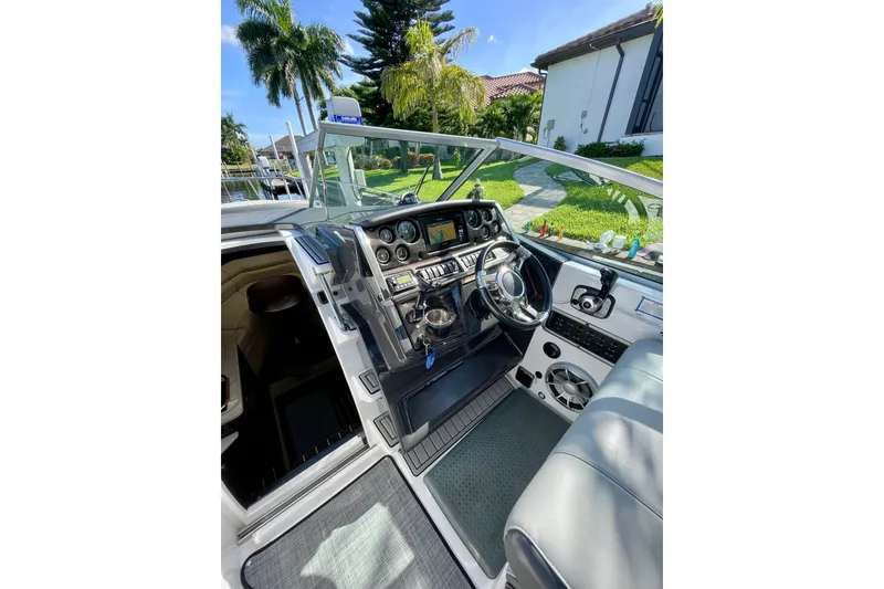 Slide: The Image of Cockpit of 2017 Monterey 295 Sport Yacht with steering wheel and control panel. - 22