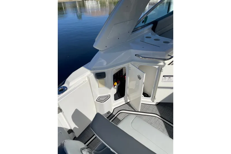 Slide: The Image of 2017 Monterey 295 Sport Yacht interior with open storage compartment and seating. - 15
