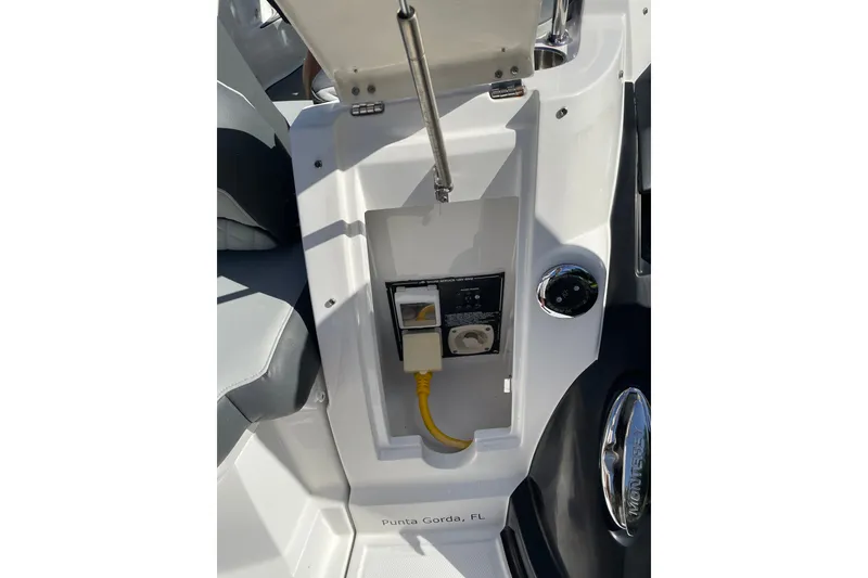 Slide: The Image of 2017 Monterey 295 Sport Yacht electrical panel with yellow power cord, Punta Gorda, FL. - 17