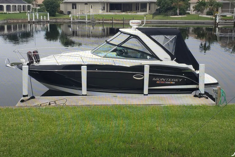 Slide: The Image of 2017 Monterey 295 Sport Yacht docked by a serene waterfront property. - 35