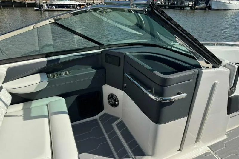 Slide: The Image of 2023 Regal 29 OBX boat interior with sleek seating and modern dashboard design. - 12