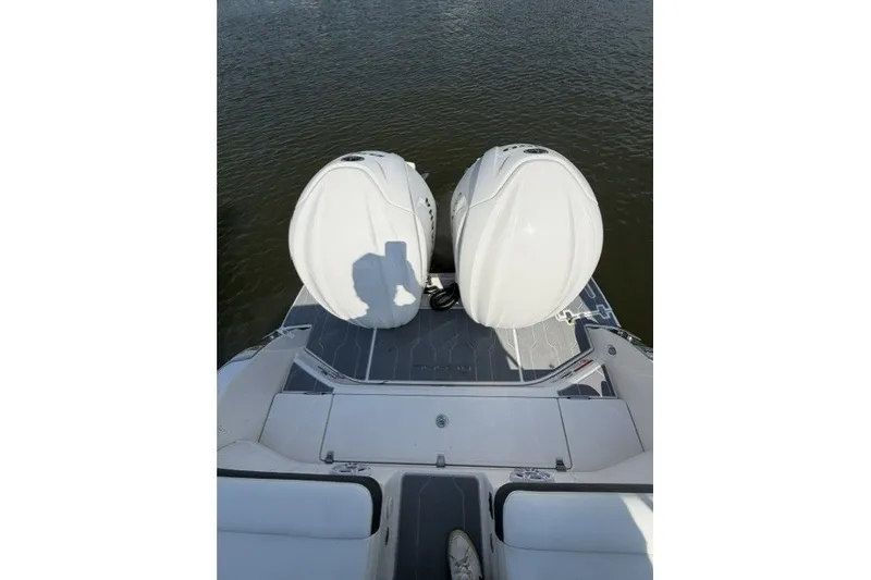 Slide: The Image of 2023 Regal 29 OBX boat with dual outboard motors on water. - 40