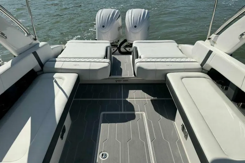 Slide: The Image of 2023 Regal 29 OBX boat interior with spacious seating and twin outboard engines. - 35