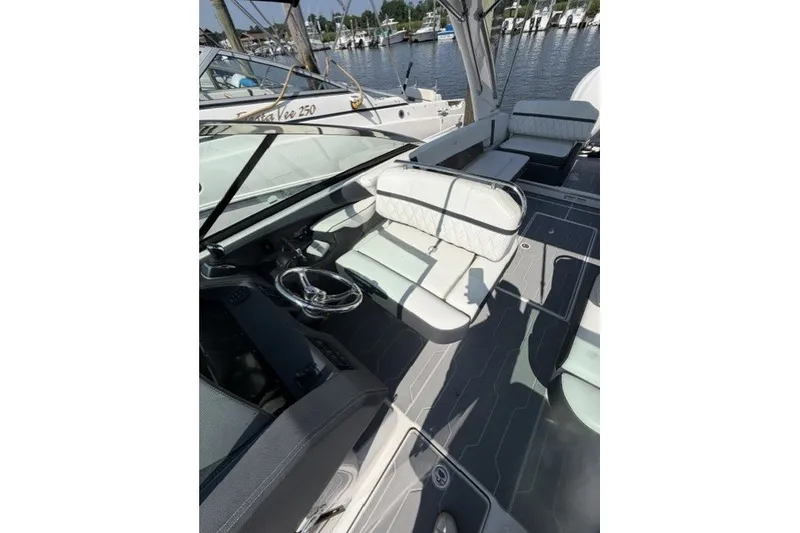 Slide: The Image of 2023 Regal 29 OBX boat interior with sleek seating and modern steering wheel. - 31