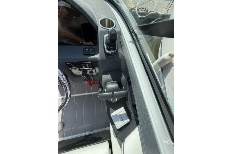 Slide: The Image of 2023 Regal 29 OBX boat cockpit with steering wheel and controls. - 9