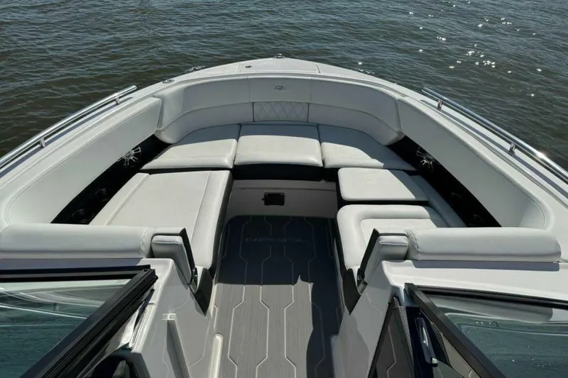 Slide: The Image of 2023 Regal 29 OBX boat interior with spacious seating on calm water. - 3