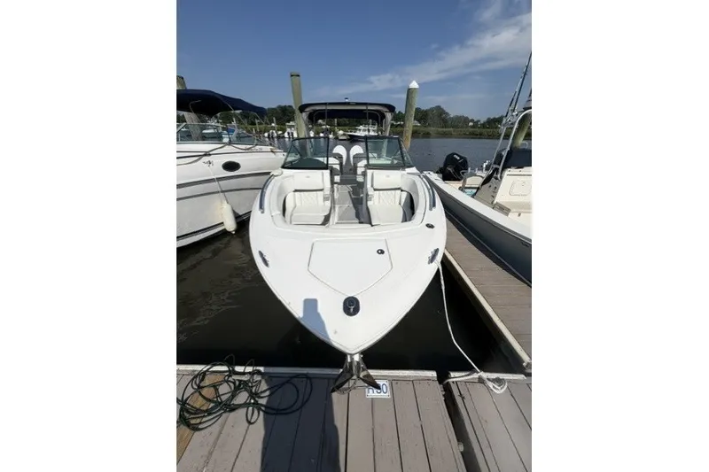 Slide: The Image of 2023 Regal 29 OBX boat docked, showcasing sleek design and spacious seating. - 2