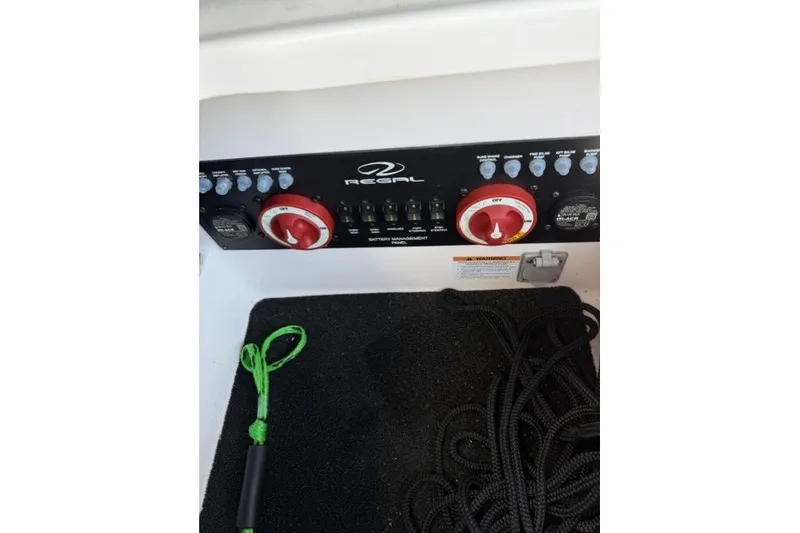 Slide: The Image of Control panel of 2023 Regal 29 OBX boat with ropes and safety equipment. - 39