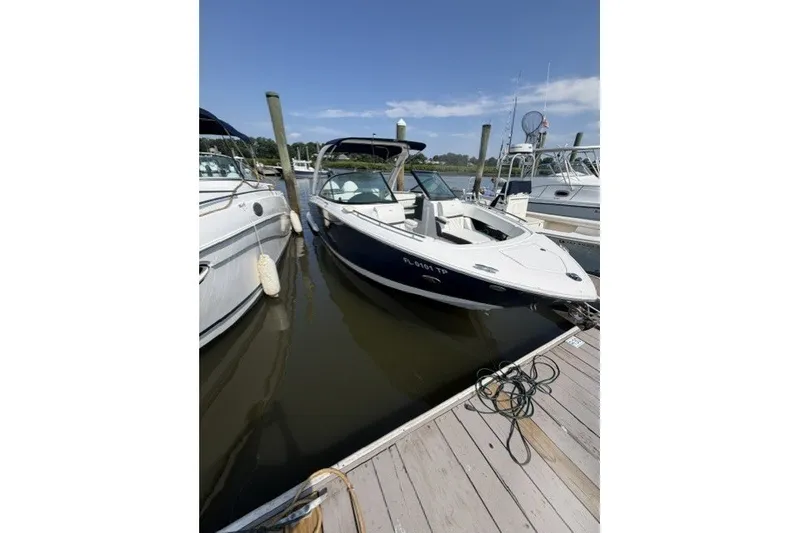 Slide: The Image of 2023 Regal 29 OBX boat docked at marina under clear blue sky. - 1