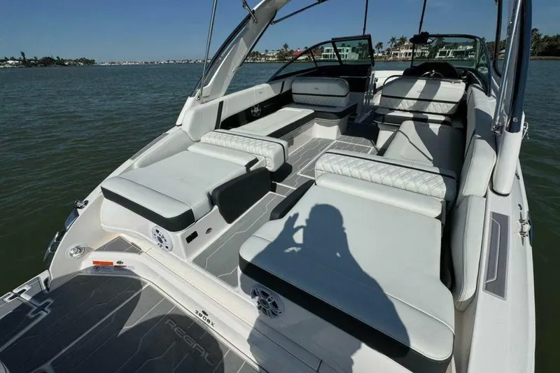 Slide: The Image of 2023 Regal 29 OBX boat interior with luxurious seating on a sunny day. - 37