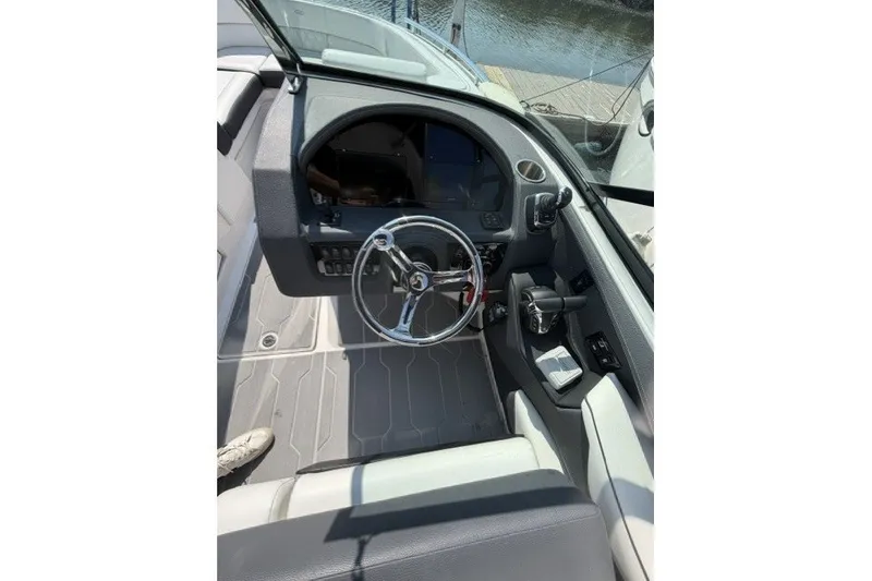 Slide: The Image of 2023 Regal 29 OBX boat cockpit with steering wheel and controls. - 7
