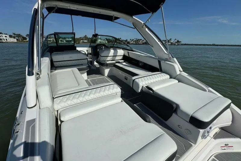 Slide: The Image of 2023 Regal 29 OBX boat interior with luxurious seating on a sunny day. - 18