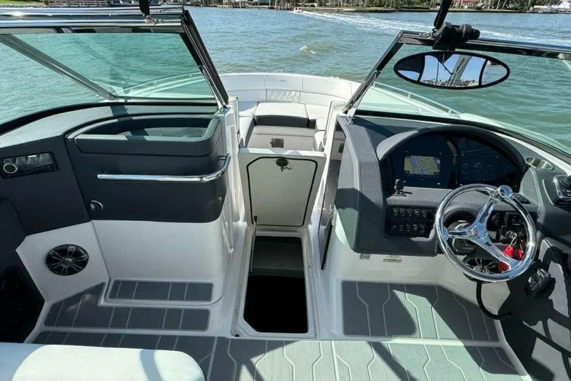 Slide: The Image of 2023 Regal 29 OBX boat cockpit with modern steering and navigation system. - 6