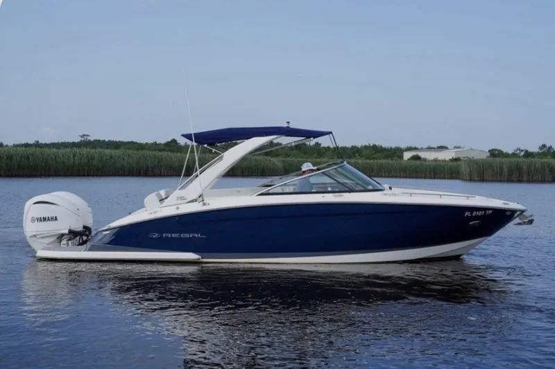 The Image of 2023 Regal 29 OBX boat with Yamaha engine on calm water. - 0