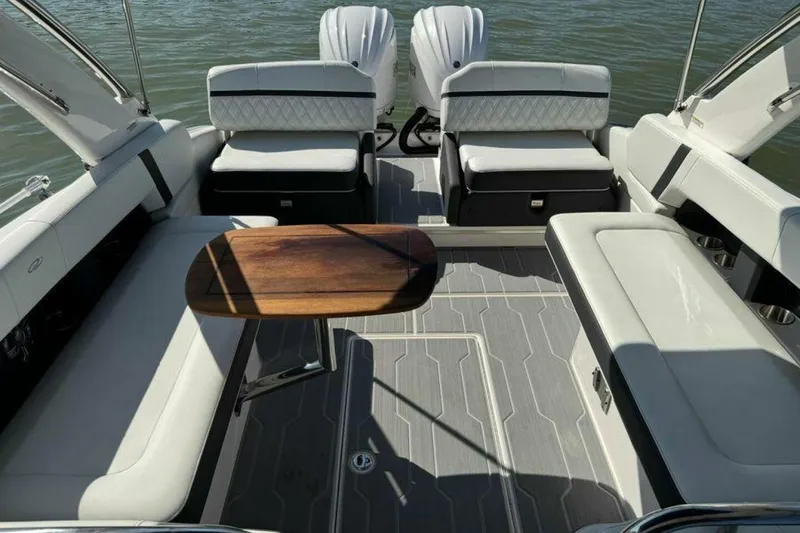 Slide: The Image of Luxurious interior of 2023 Regal 29 OBX boat with elegant seating and wooden table. - 36