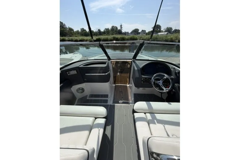 Slide: The Image of Interior view of 2023 Regal 29 OBX boat cockpit with steering wheel and seating. - 25