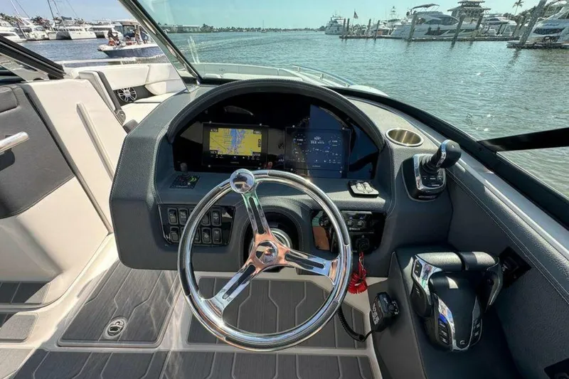 Slide: The Image of 2023 Regal 29 OBX boat dashboard with steering wheel and navigation display. - 5