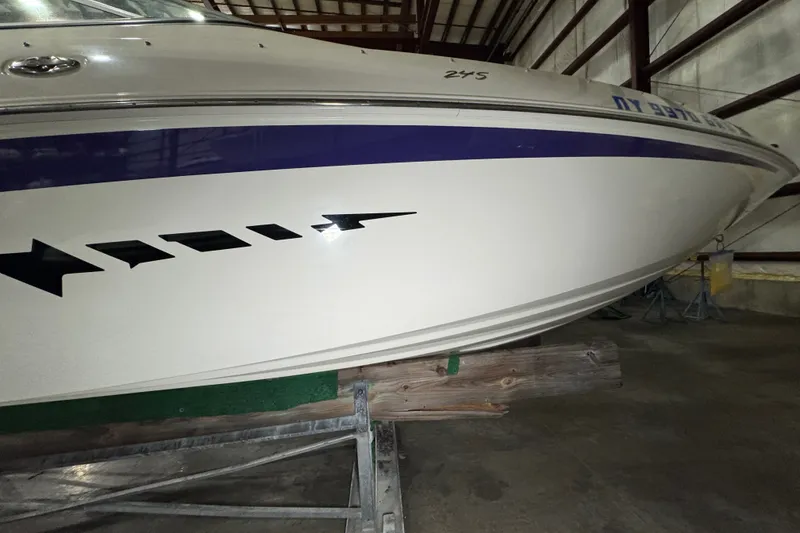 Slide: The Image of 2009 Baja 24 H2X Boss boat in storage, featuring sleek design and bold graphics. - 18