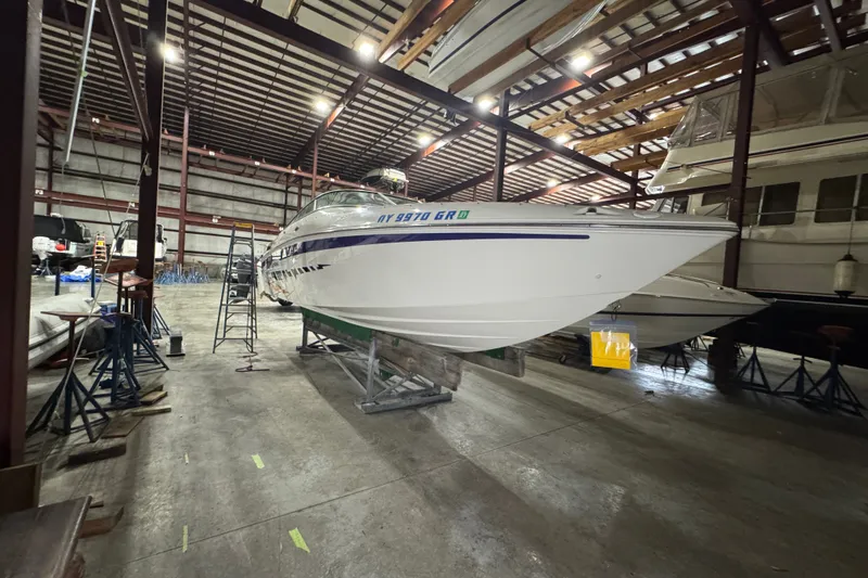 Slide: The Image of 2009 Baja 24 H2X Boss boat stored in a spacious indoor facility. - 14