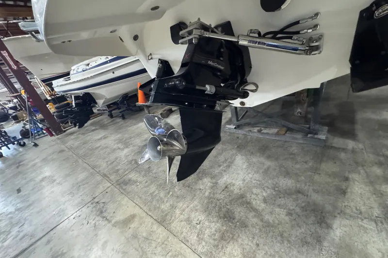 Slide: The Image of 2009 Baja 24 H2X Boss boat in a garage, showing propeller and engine details. - 25