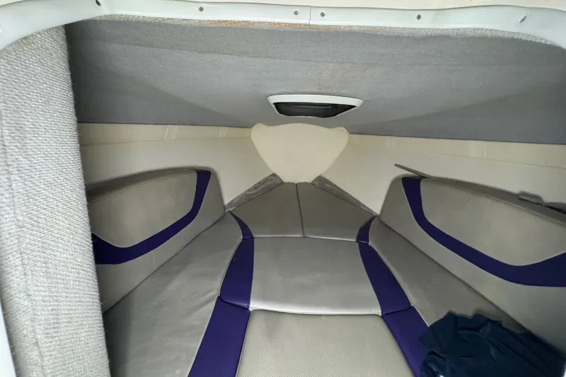 Slide: The Image of Interior cabin of a 2009 Baja 24 H2X Boss boat with gray and purple seating. - 37