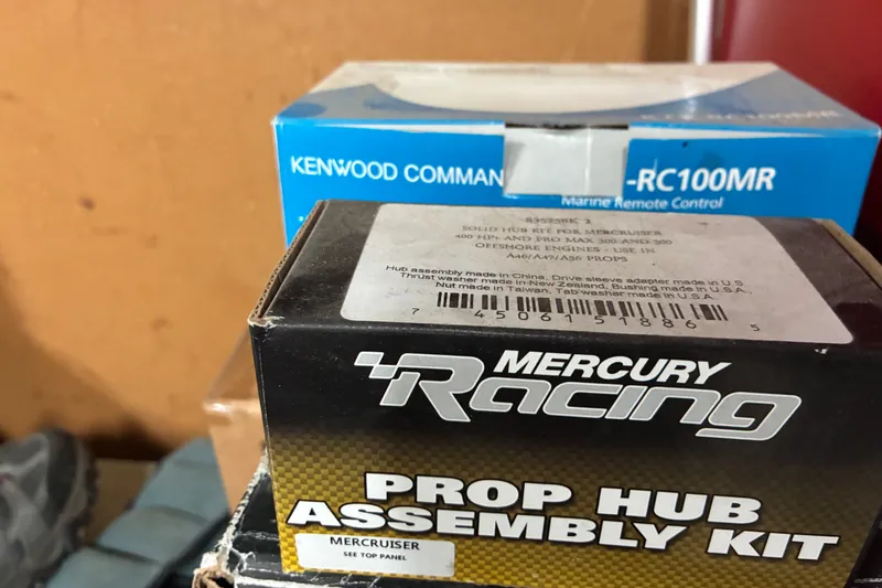 Slide: The Image of Boxes of Mercury Racing prop hub assembly kit and Kenwood marine remote control. - 49