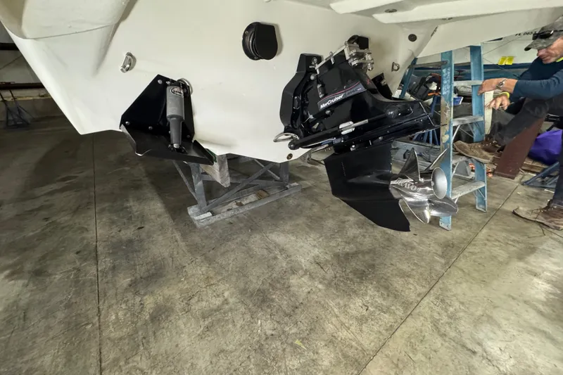 Slide: The Image of 2009 Baja 24 H2X Boss boat with MerCruiser outdrive in a garage setting. - 23
