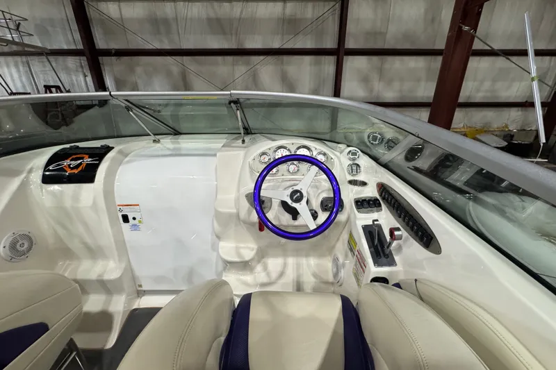 Slide: The Image of 2009 Baja 24 H2X Boss boat interior with steering wheel and dashboard controls. - 40