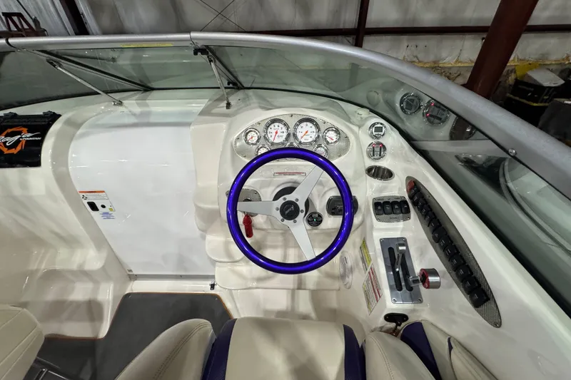 Slide: The Image of 2009 Baja 24 H2X Boss boat cockpit with purple steering wheel and instrument panel. - 29