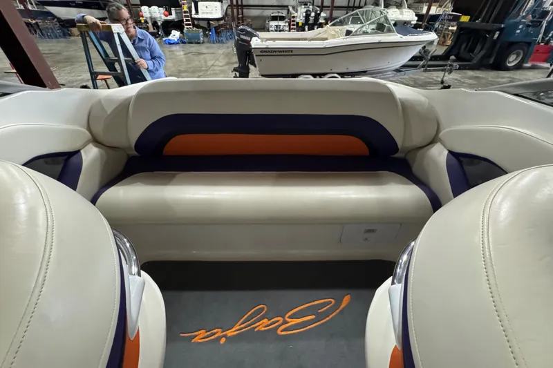 Slide: The Image of Interior of a 2009 Baja 24 H2X Boss boat with beige and orange seating. - 38