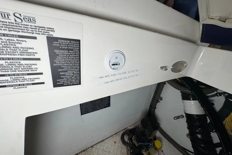 Slide: The Image of 2009 Baja 24 H2X Boss boat interior with maintenance labels and equipment. - 33