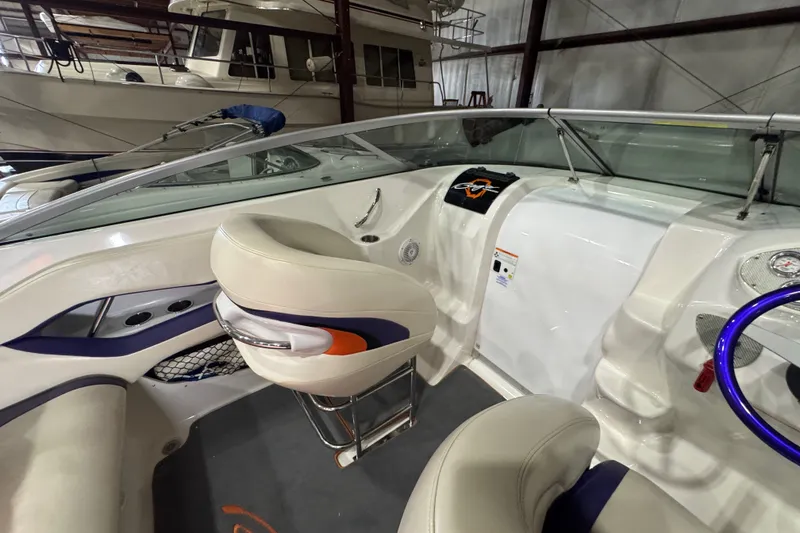 Slide: The Image of Interior of a 2009 Baja 24 H2X Boss boat, featuring sleek seating and modern controls. - 30