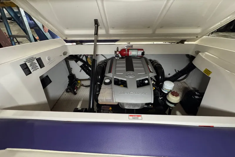 Slide: The Image of 2009 Baja 24 H2X Boss boat engine compartment with MerCruiser engine and fire extinguisher. - 34