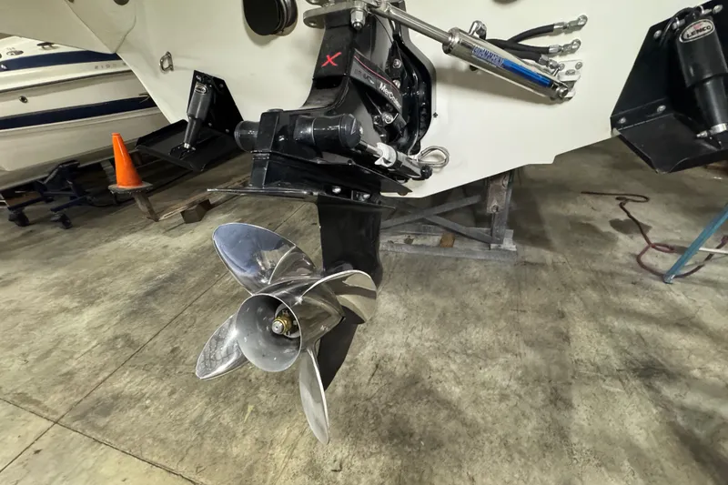 Slide: The Image of 2009 Baja 24 H2X Boss boat propeller and stern drive in a garage setting. - 27