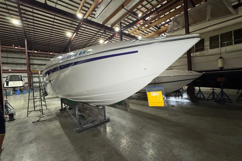 Slide: The Image of 2009 Baja 24 H2X Boss boat in storage, showcasing sleek design and white hull. - 15