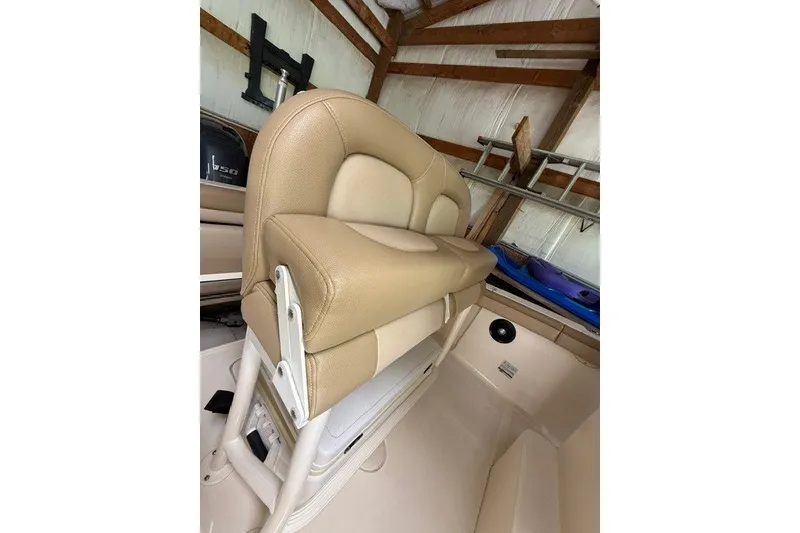 Slide: The Image of 2020 Scout 215 XSF boat interior with tan seating in a storage area. - 17