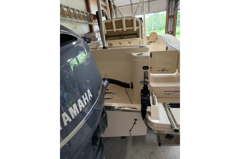 Slide: The Image of 2020 Scout 215 XSF boat with Yamaha engine in a garage setting. - 23