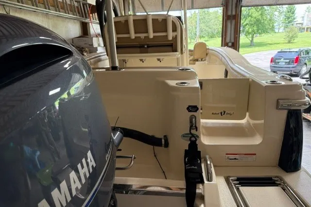 Slide: The Image of 2020 Scout 215 XSF boat with Yamaha engine in a garage setting. - 22