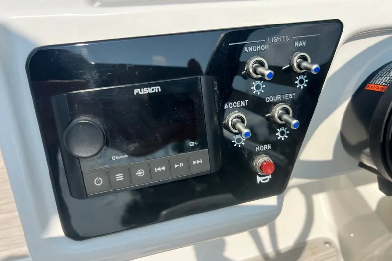 Slide: The Image of Control panel of 2023 Sea Ray SPX 190 boat with switches and audio system. - 9