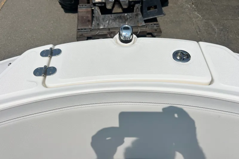 Slide: The Image of 2023 Sea Ray SPX 190 boat deck with chrome fittings and white upholstery. - 22