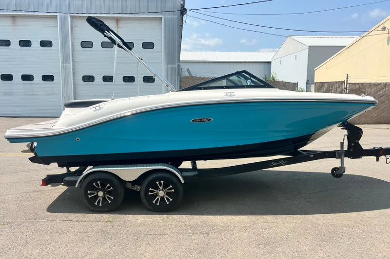 Slide: The Image of 2023 Sea Ray SPX 190 boat on trailer, blue hull, parked outdoors. - 30