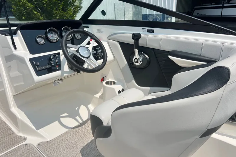 Slide: The Image of Interior view of 2023 Sea Ray SPX 190 boat cockpit with steering wheel and controls. - 6