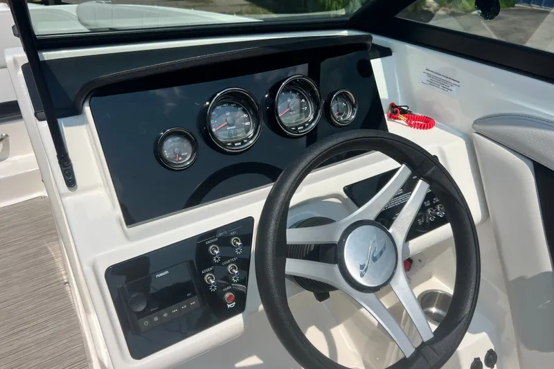 Slide: The Image of 2023 Sea Ray SPX 190 dashboard with steering wheel and instrument panel. - 7