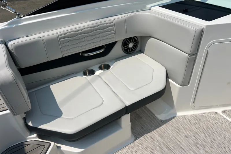 Slide: The Image of 2023 Sea Ray SPX 190 boat interior with cushioned seating and cup holders. - 24