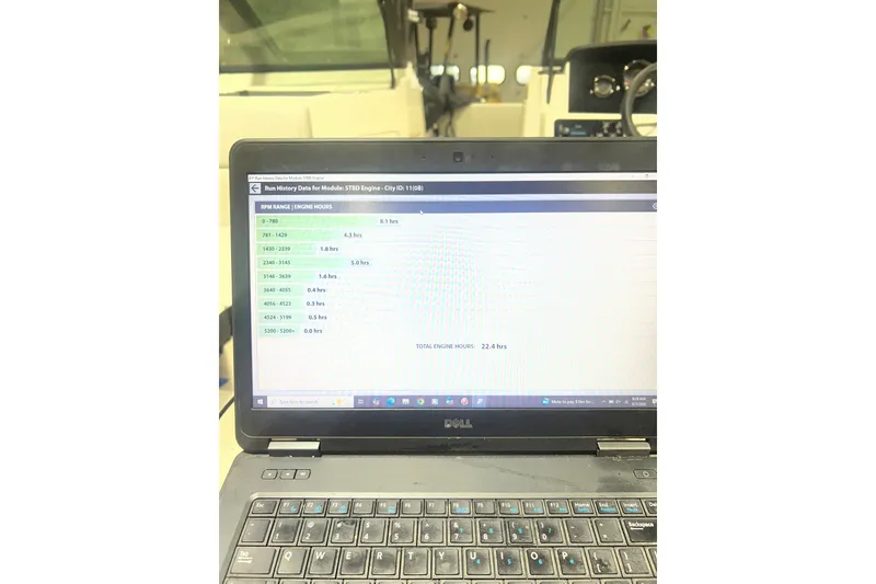 Slide: The Image of Laptop displaying engine run history data for 2023 Sea Ray SPX 190 boat. - 10