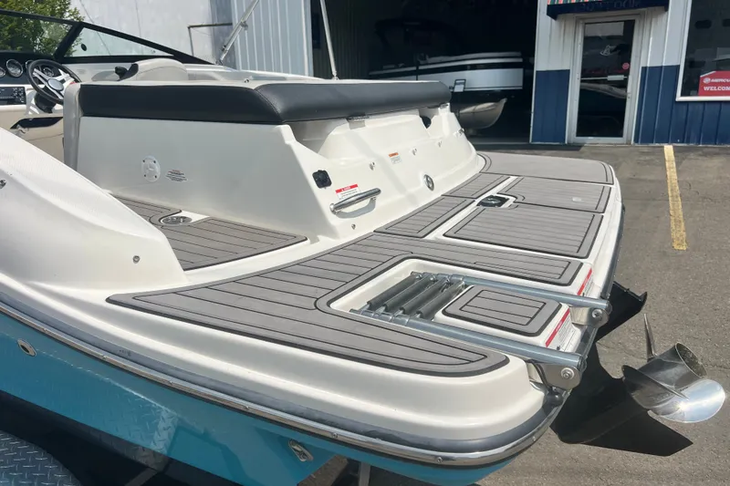 Slide: The Image of 2023 Sea Ray SPX 190 boat with swim platform and ladder, parked outside a showroom. - 16