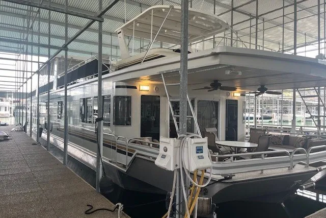 Slide: The Image of Houseboat docked in marina, Fantasy 20x100 model, 2006, featuring spacious deck and modern amenities. - 1