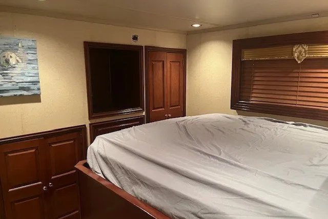 Slide: The Image of Luxurious bedroom with wooden cabinets, large bed, and wall art in a 2006 Fantasy model. - 36