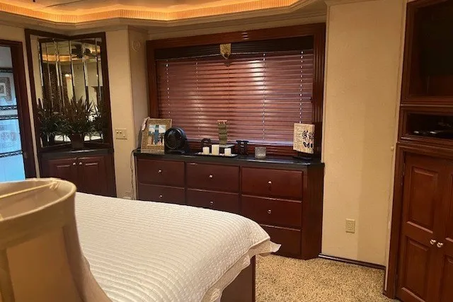 Slide: The Image of Luxurious bedroom interior in a 2006 Fantasy 20x100 model, featuring elegant wooden furnishings. - 55